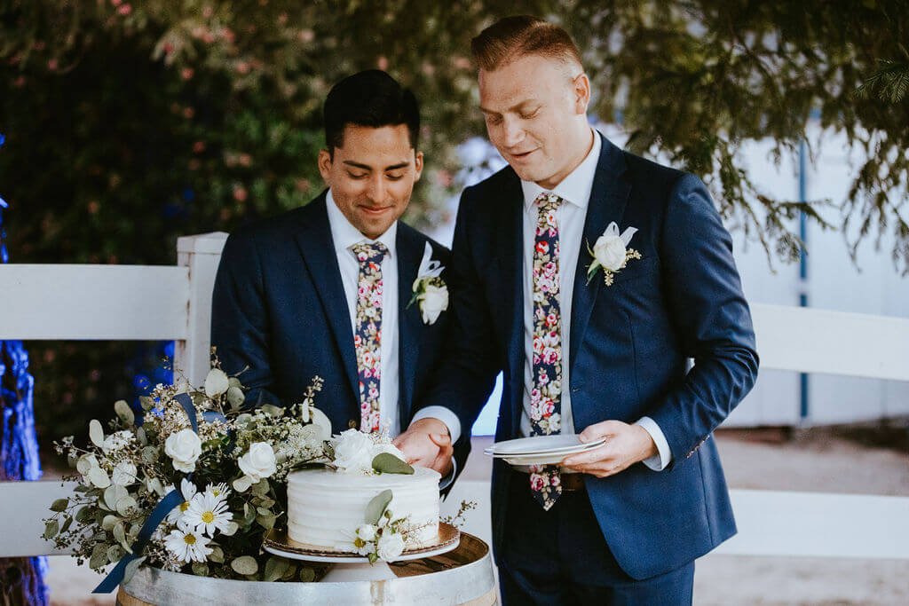 Grooms cutting wedding cake at backyard Southern California wedding