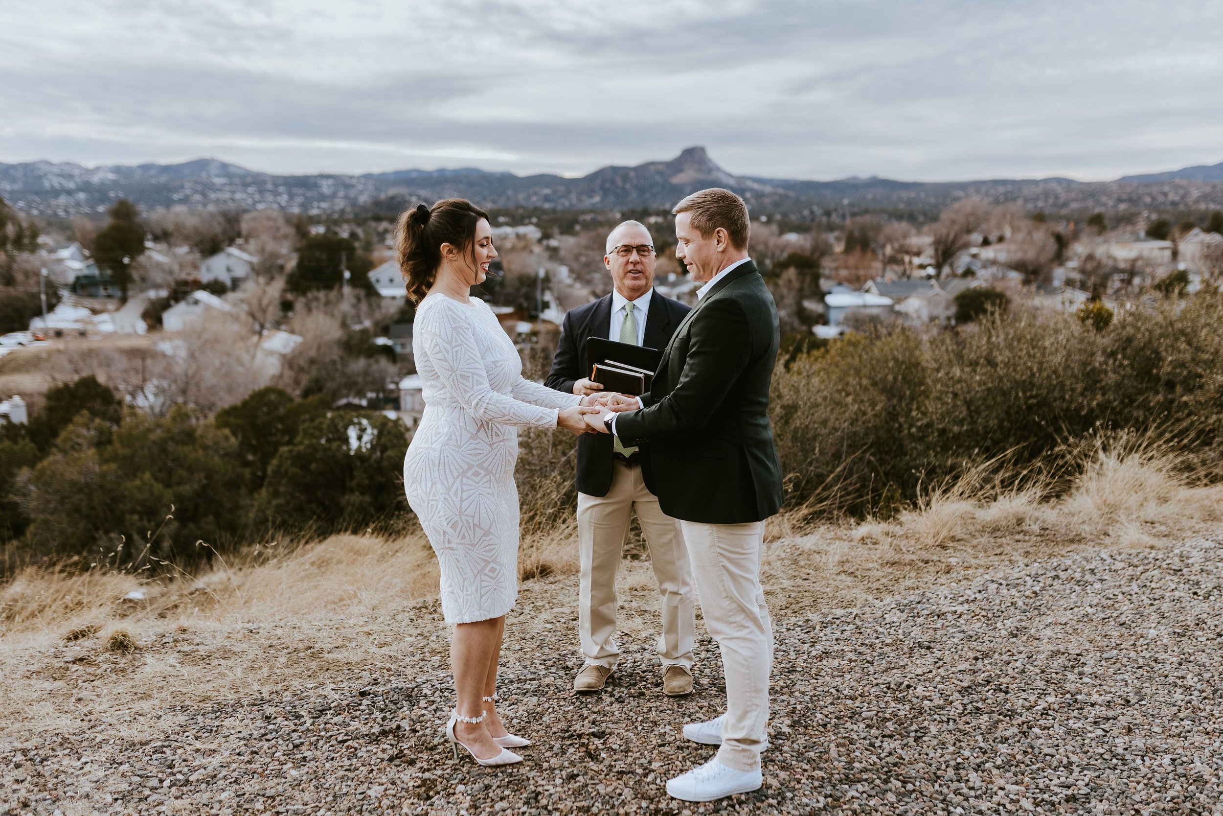 Bride and groom hold hands during Prescott elopement ceremony