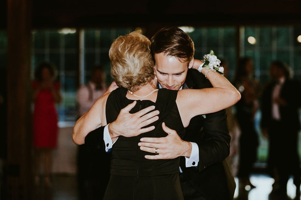 Groom hugs mother after first dance at Orchard Ridge Farms wedding