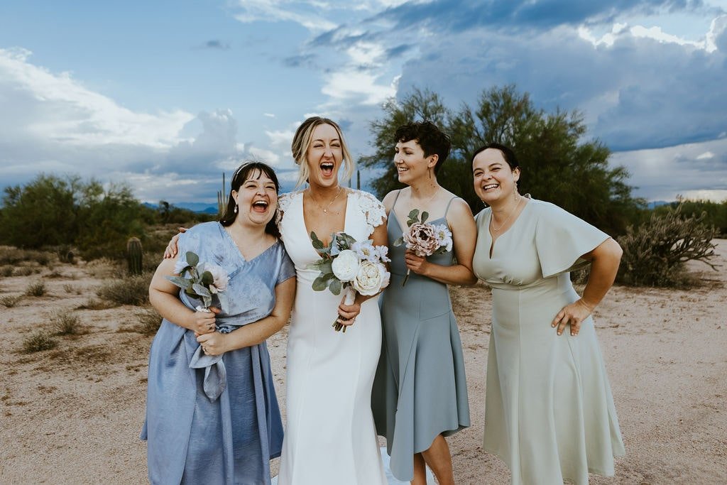 Bride laughs with her wedding party at fall wedding in Arizona