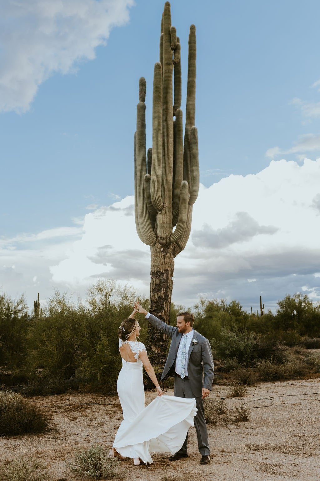 Bride and groom dance in the desert during fall wedding in Arizona