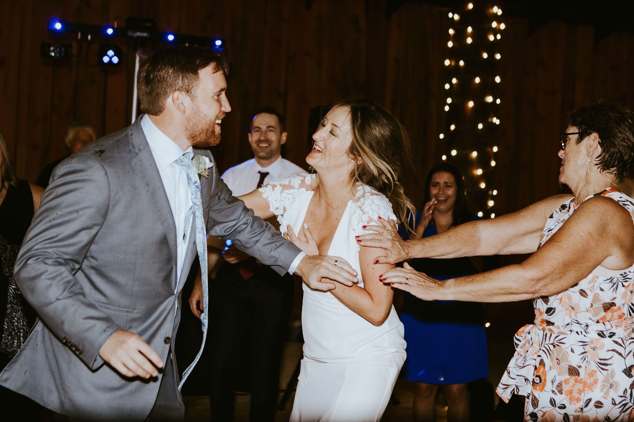 Bride and groom dancing with guests at their fall wedding reception in Arizona