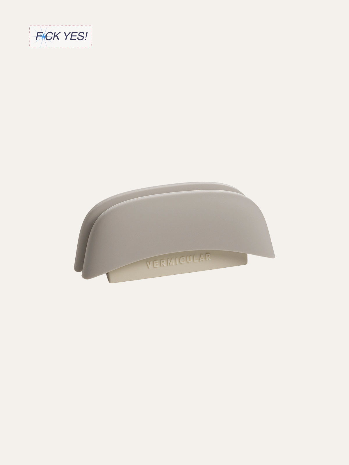 A minimalist, beige-colored stapler with the word 'VERMICULAR' embossed on it, set against a plain, light background.