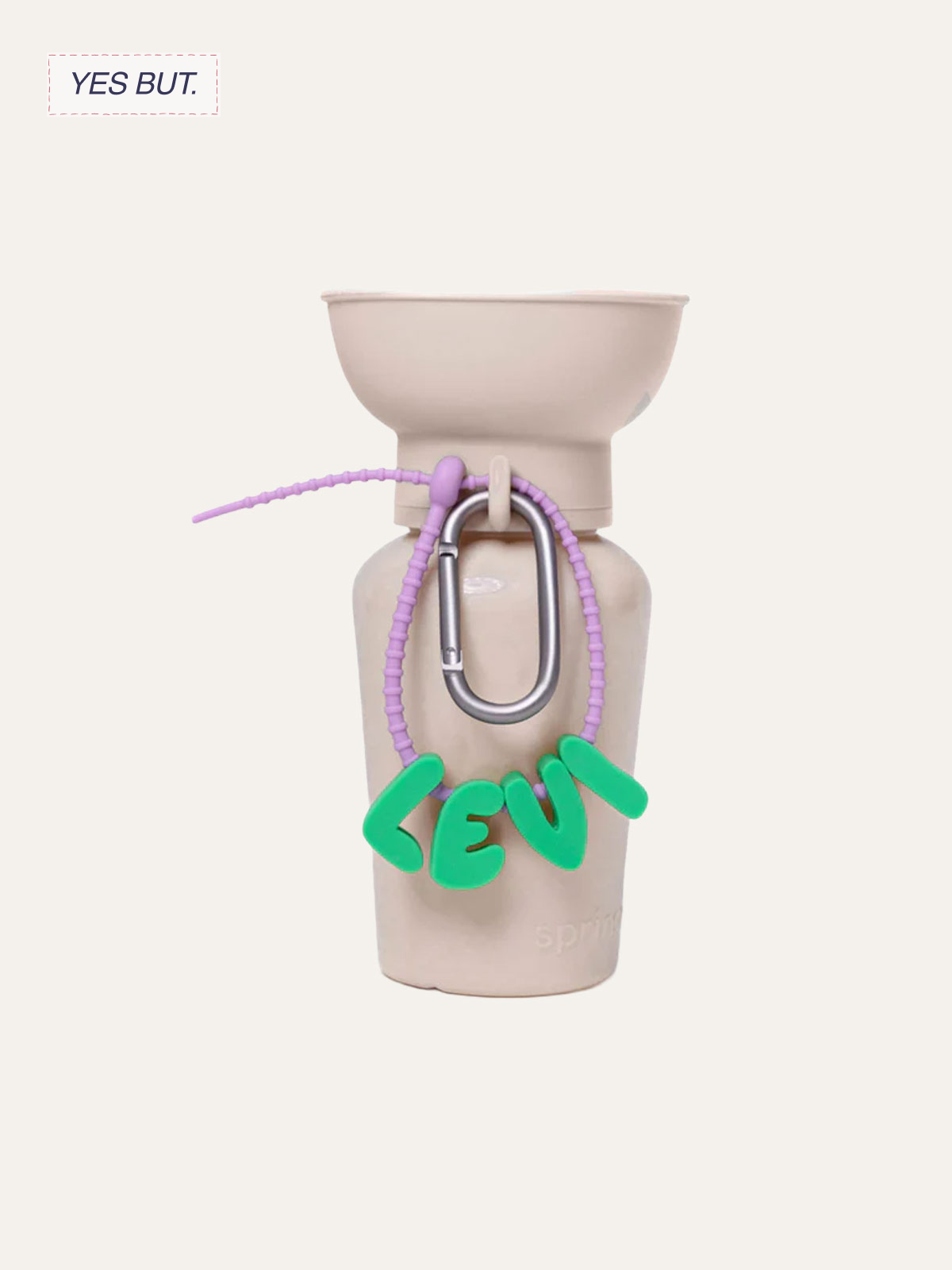 A ceramic vase with a pinkish color, decorated with a purple beaded necklace, a silver carabiner, and a green word 'LOVE' hanging from the necklace.