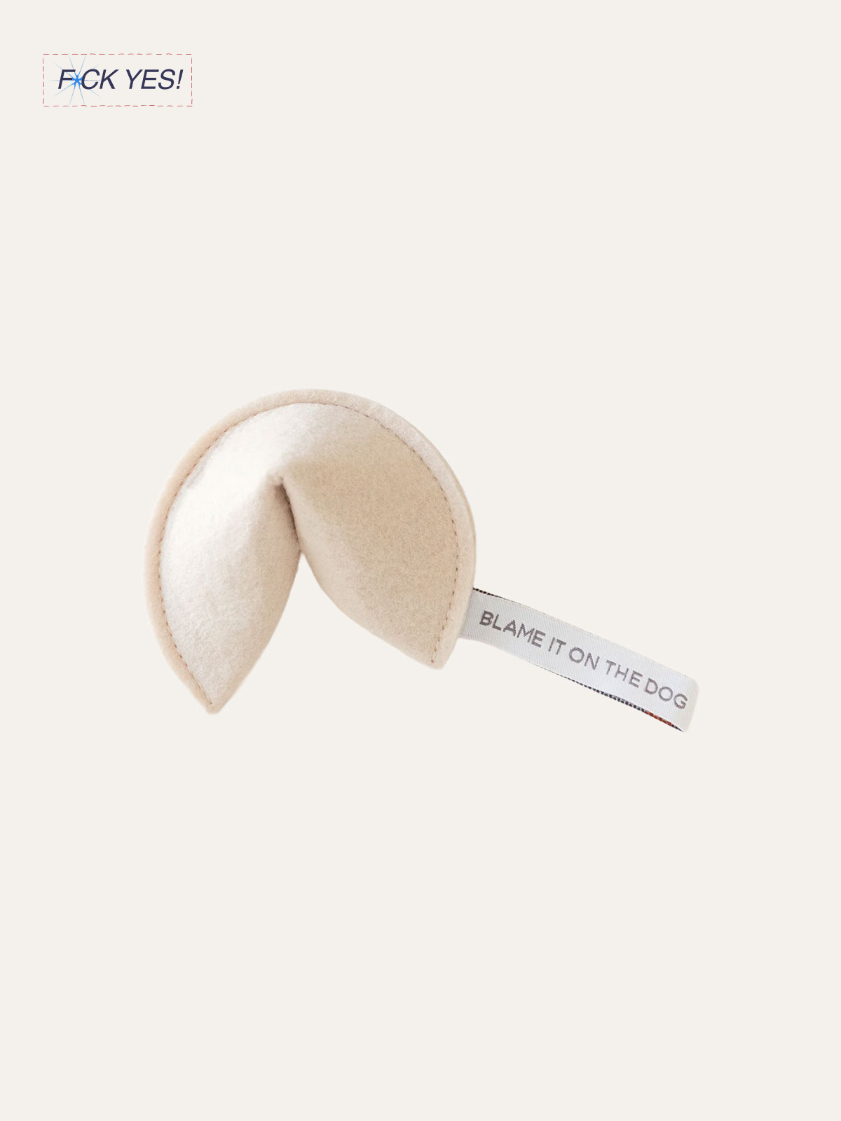A plush toy shaped like a human butt with a tag that says "Blame it on the dog." The toy is light beige and looks soft.