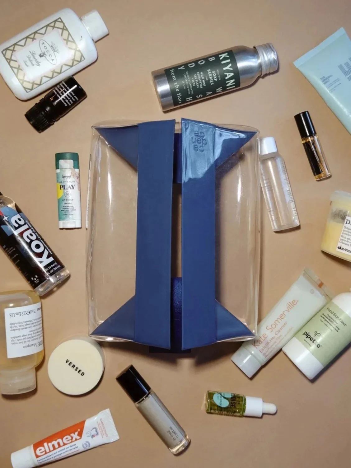 Various skincare, beauty, and personal care products arranged around a geometric-shaped box on a table.