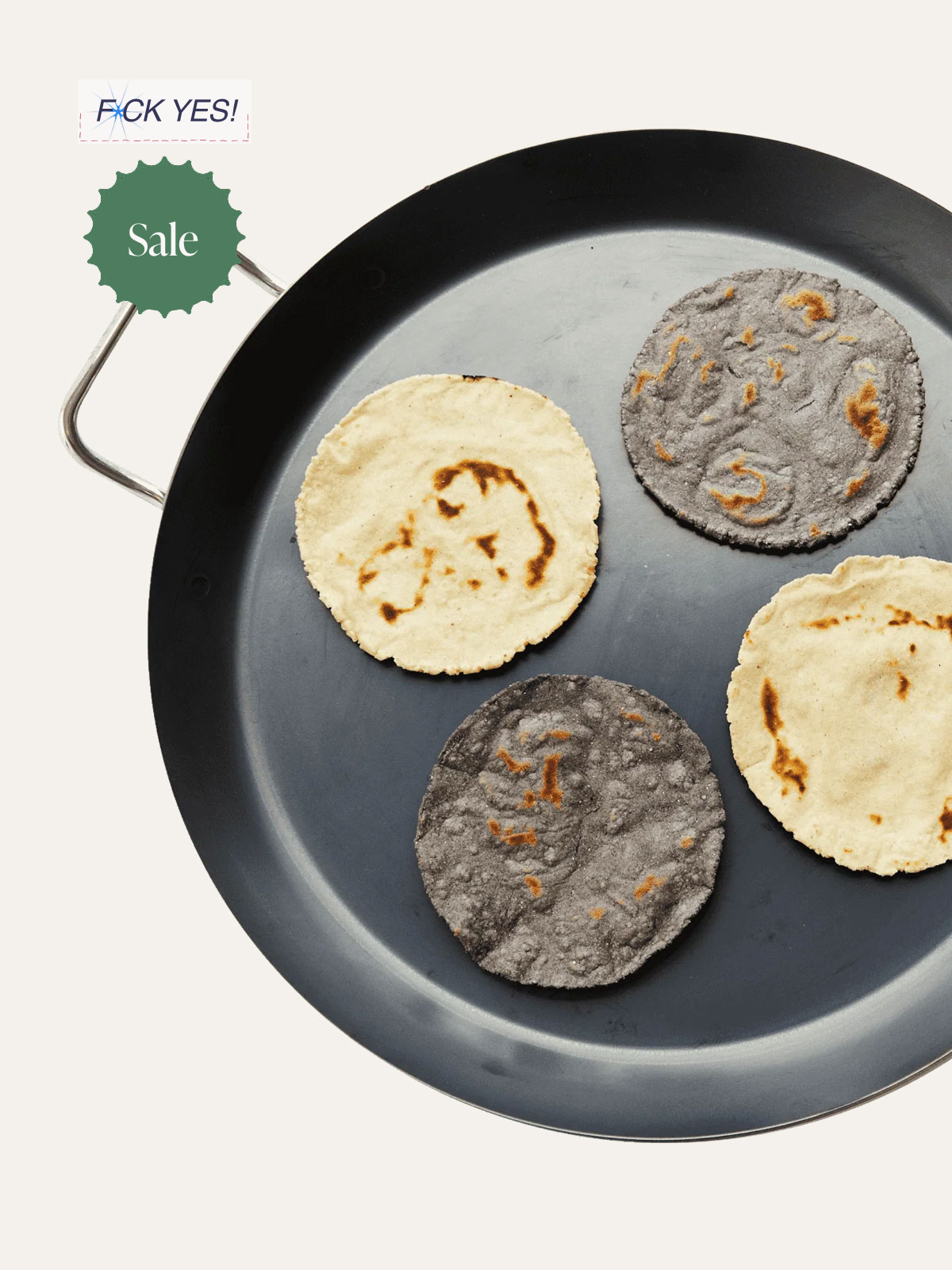 Four rice cakes on a black frying pan, two are plain and toasted, and two are purple with orange bits. There are sale tags attached to the pan, and a note in the top left corner that says 'F**K YES!'
