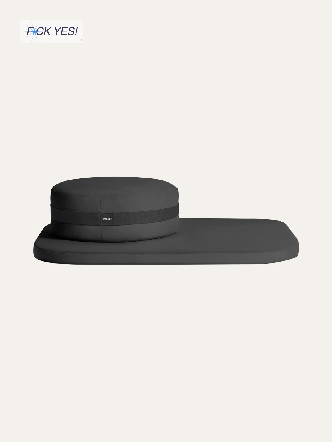 A black meditation cushion with a matching rectangular mat on a light background.
