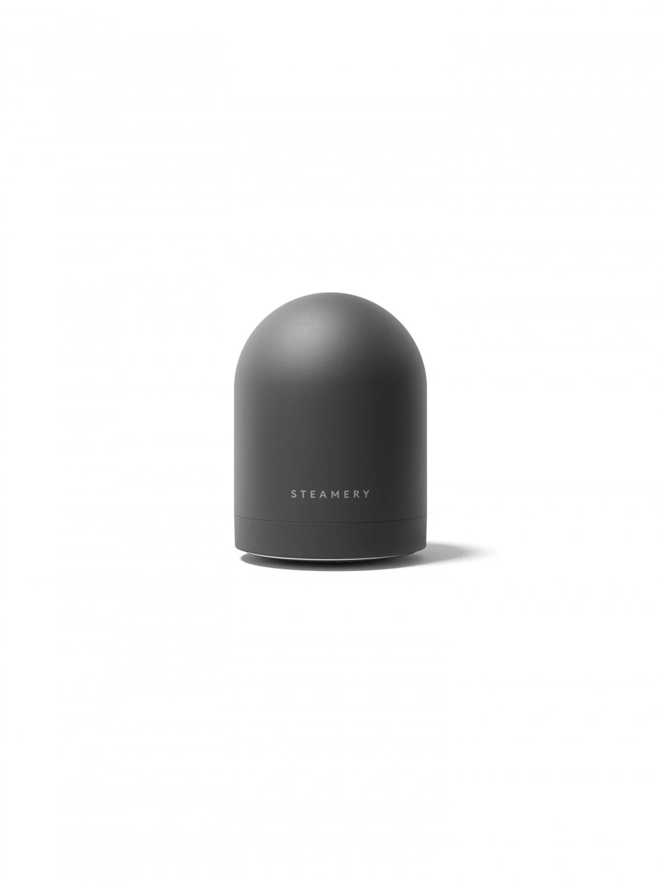 Gray, dome-shaped device with the brand name STEAMERY on it, standing on a white surface against a plain white background.