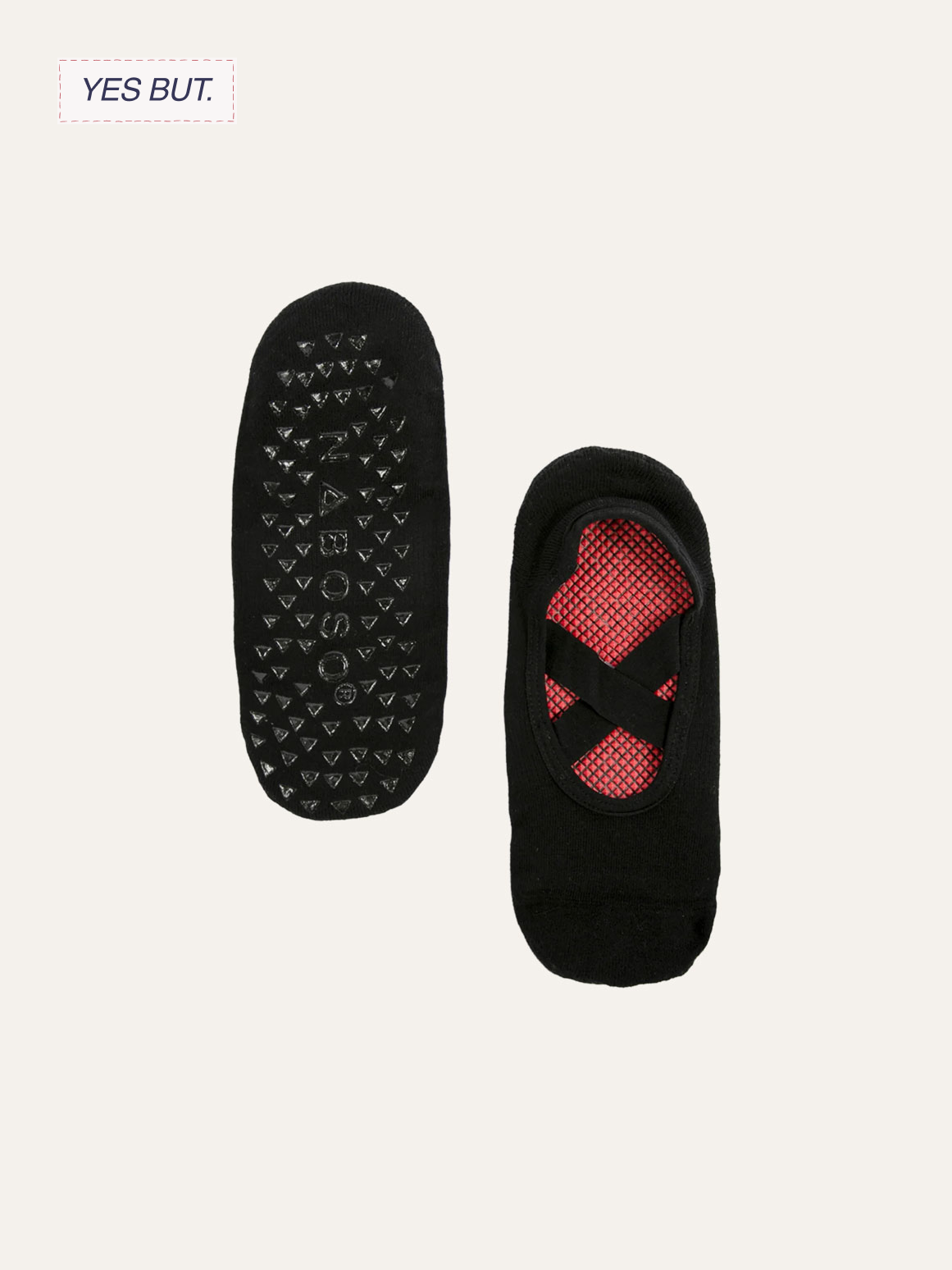 Pair of black no-show socks with red and black grid pattern on the inside, one sock showing the sole with black rubber grip dots and the brand name 'SLOGGI'.