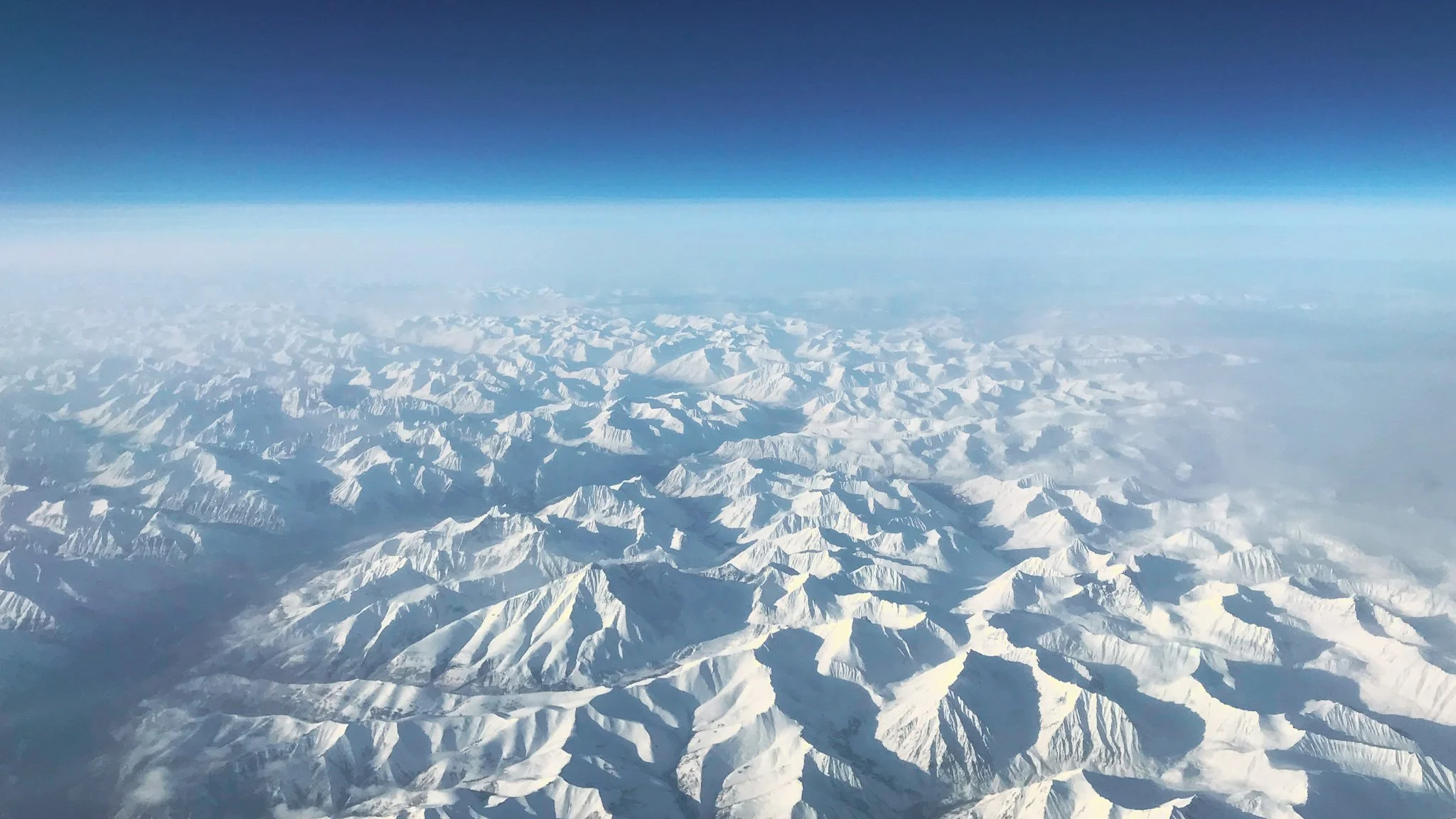 Image of snowy mountains in Russia shot from a plane