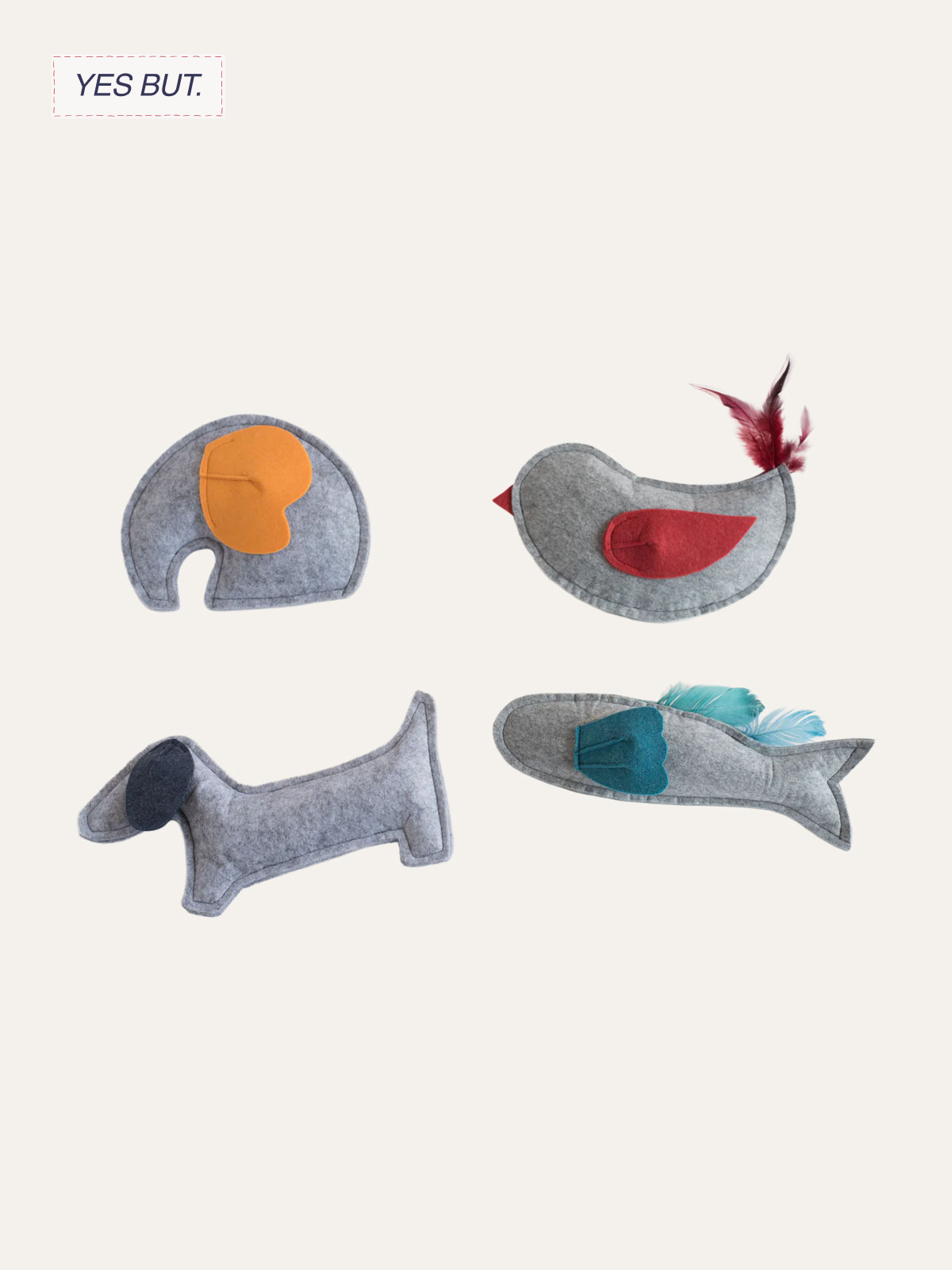 Four felt plush toys resembling animals with colorful details: an elephant with orange ear and trunk, a bird with red wing and feather, a dachshund with dark nose, and a fish with blue fin.
