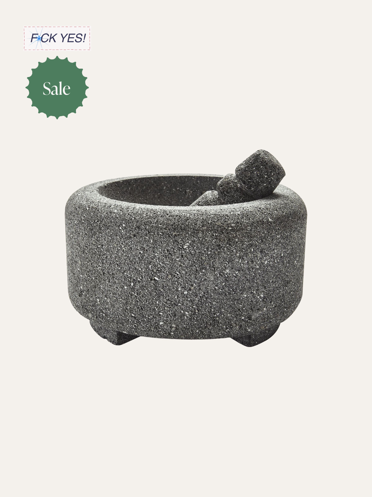 Gray stone mortar with two pestle stones inside, used for grinding spices or herbs.