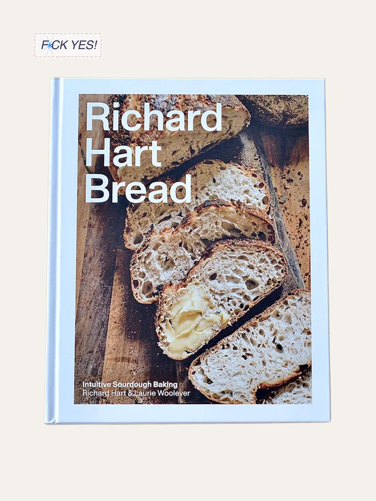 Book titled Richard Hart Bread featuring a photo of sliced sourdough bread with butter on a wooden cutting board.