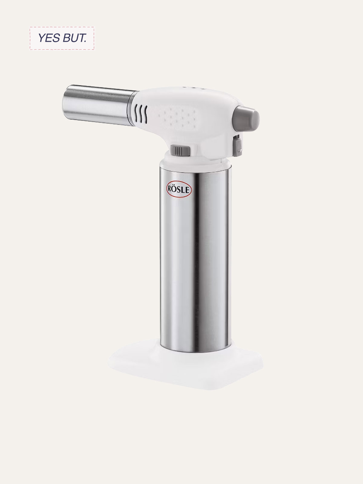 A handheld kitchen torch with a white and silver design, labeled 'RÖSLE', positioned on a white surface against a light background.