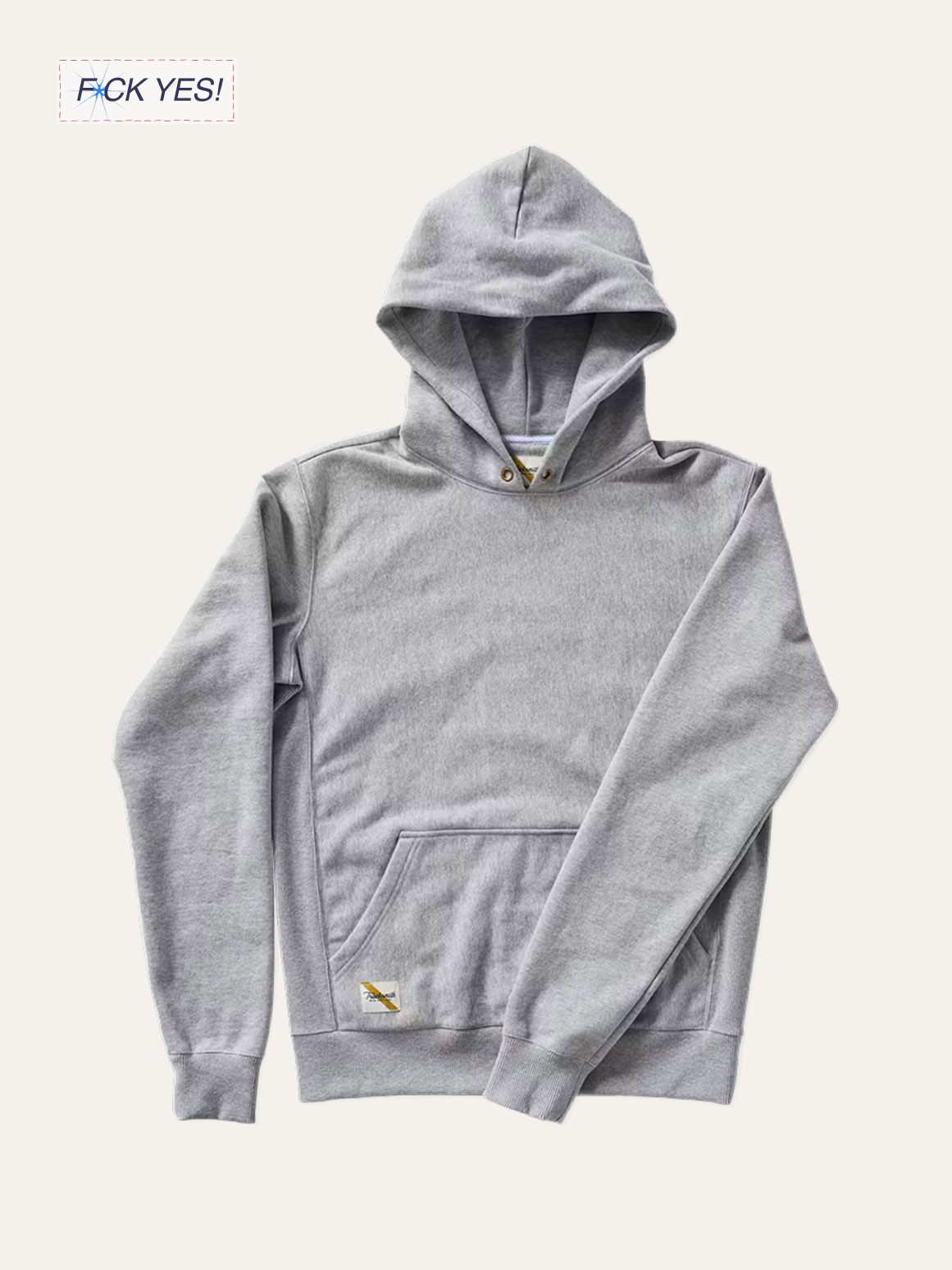A gray hoodie with a front pocket and a drawstring hood, laid flat on a cream background.