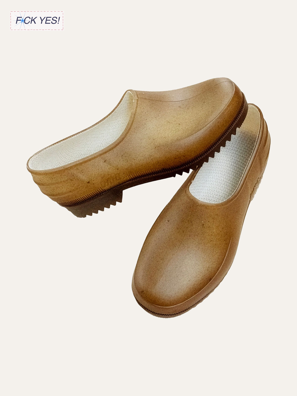 Pair of tan slip-on shoes with white insoles and black tread soles.
