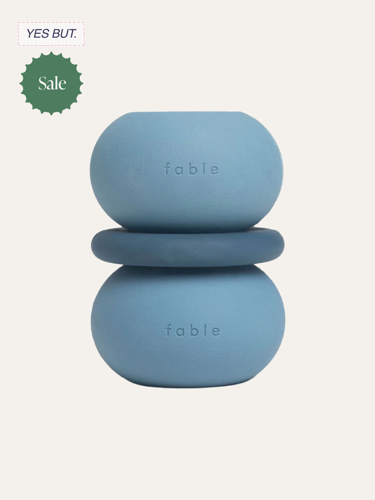 A minimalist blue soap holder with two oval-shaped soaps stacked on top of each other, each embossed with the word 'fable.' The background is plain, and there are sale and yes but labels in the top left corner.