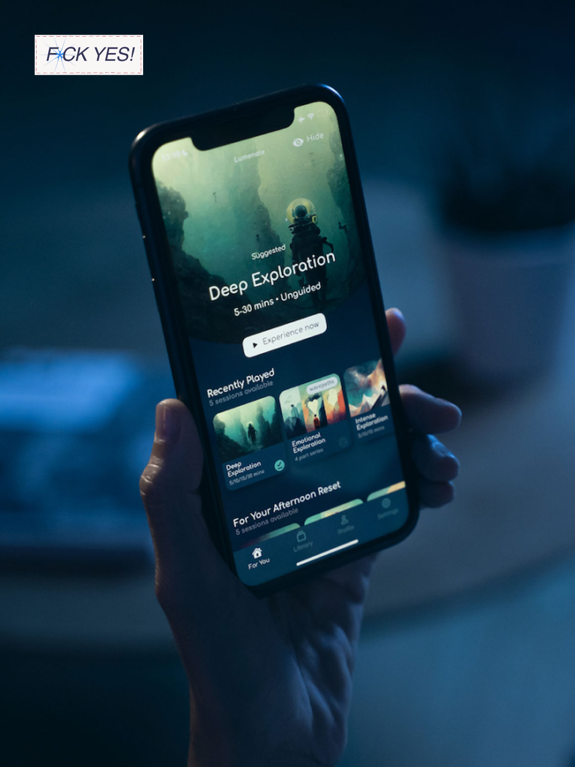 Person holding a smartphone displaying a virtual reality app called 'Deep Exploration' with a background of a diver in an underwater scene.