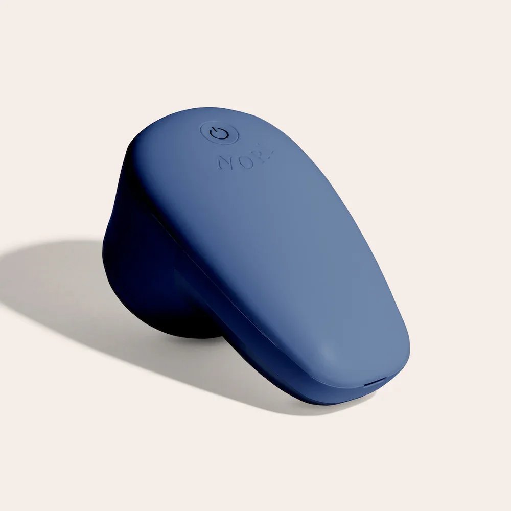 Blue wireless computer mouse on off-white background with shadow.