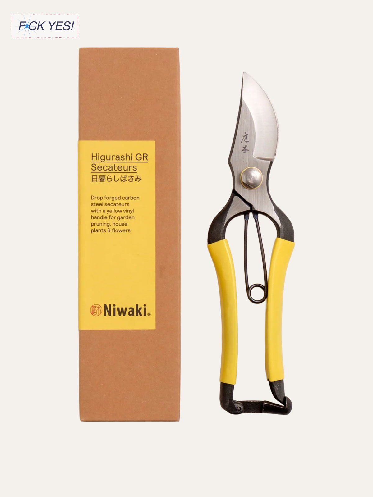 Japanese garden secateurs with yellow handles and a curved stainless steel blade next to a brown box labeled with product information.