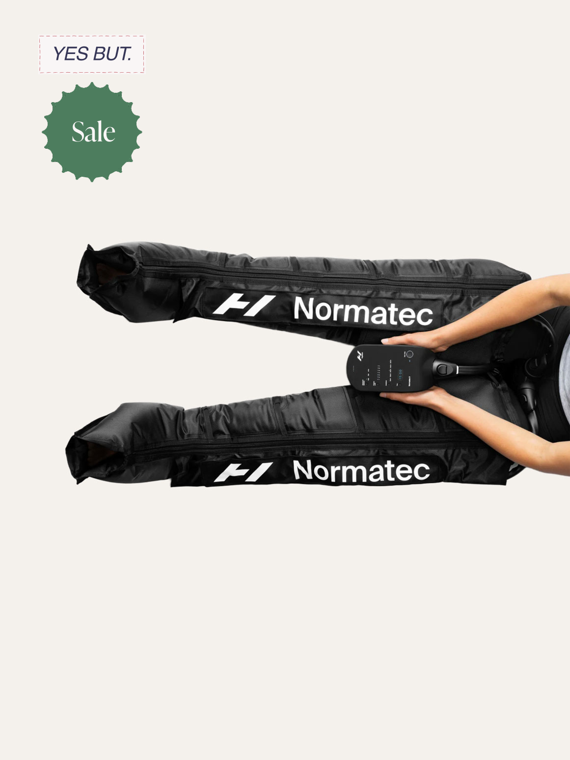A person holding a black racing wheel controller with a digital display, placed between two black racing pedal covers branded with the logo 'Normatec' and the letter 'F1'.