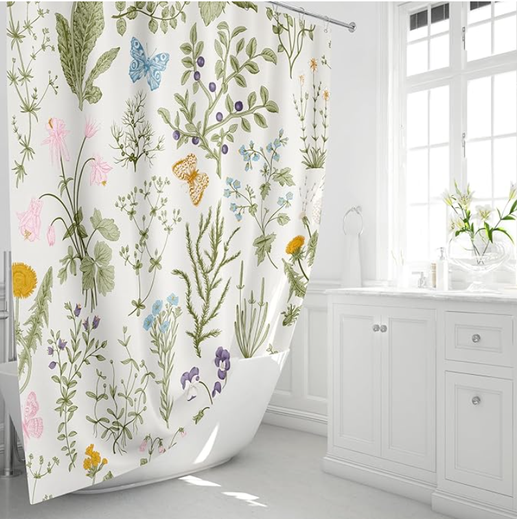 Bright bathroom with a botanical print shower curtain featuring flowers, butterflies, and greenery.