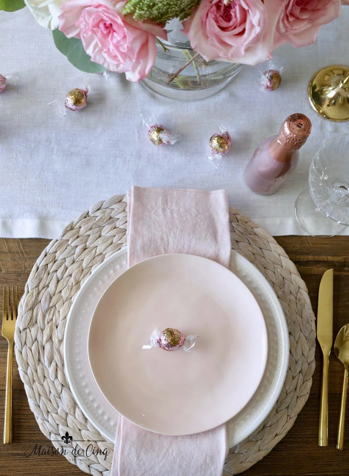 Simple dining table set for two with candles and cloth napkins