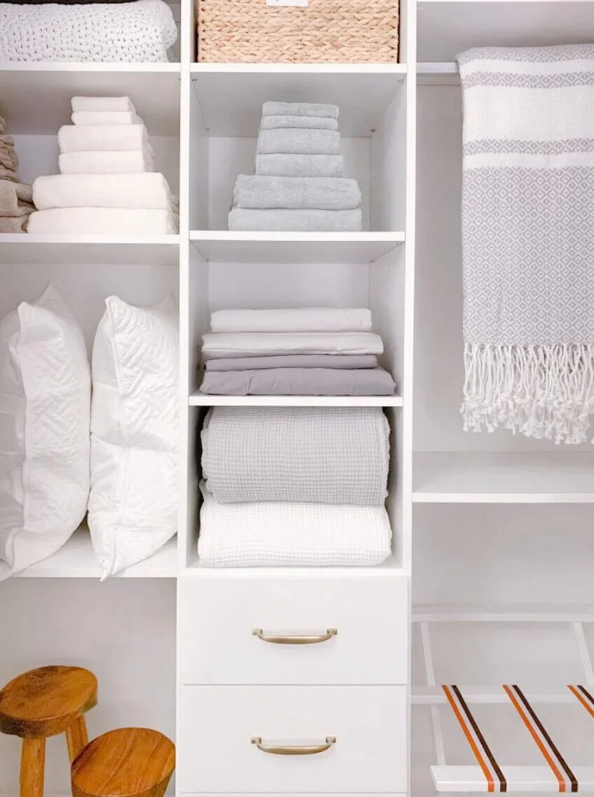Neatly organized linen closet with folded towels and sheets