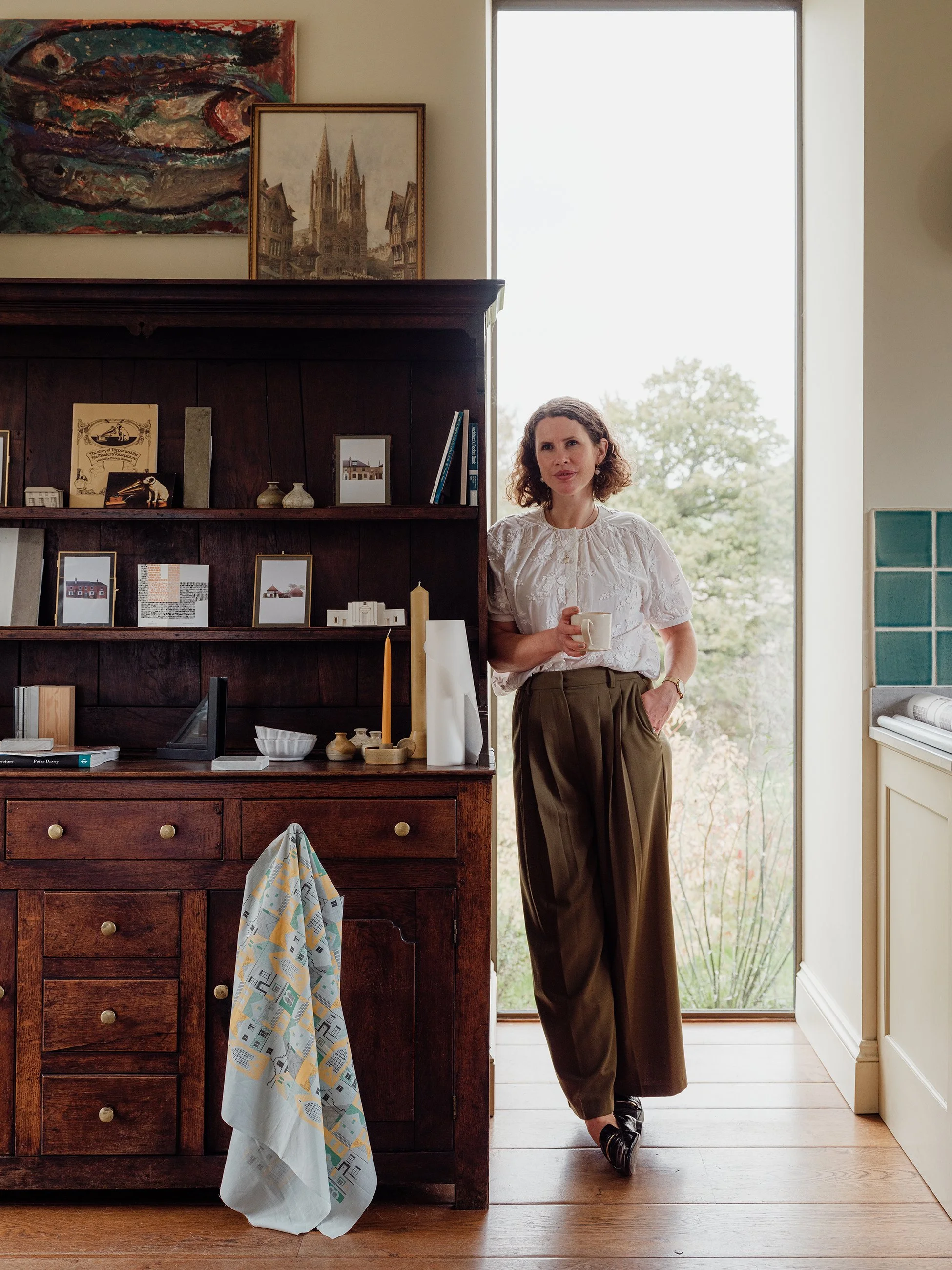 Portrait of heritage architect Rosie McLaren by Elliot Sheppard. Shows Rosie's interests and family background including her Huguenot Grandfather's artwork His Master's Voice