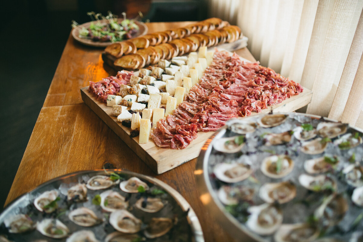  A delectable spread of assorted meats, cheeses, and oysters beautifully displayed for guests at a private event, offering a delightful culinary experience with a variety of flavors and textures. 