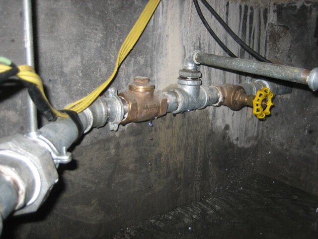 Piping inside the pump tank.