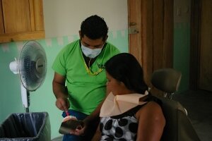 Dr. Luis with a patient in the dental clinic.