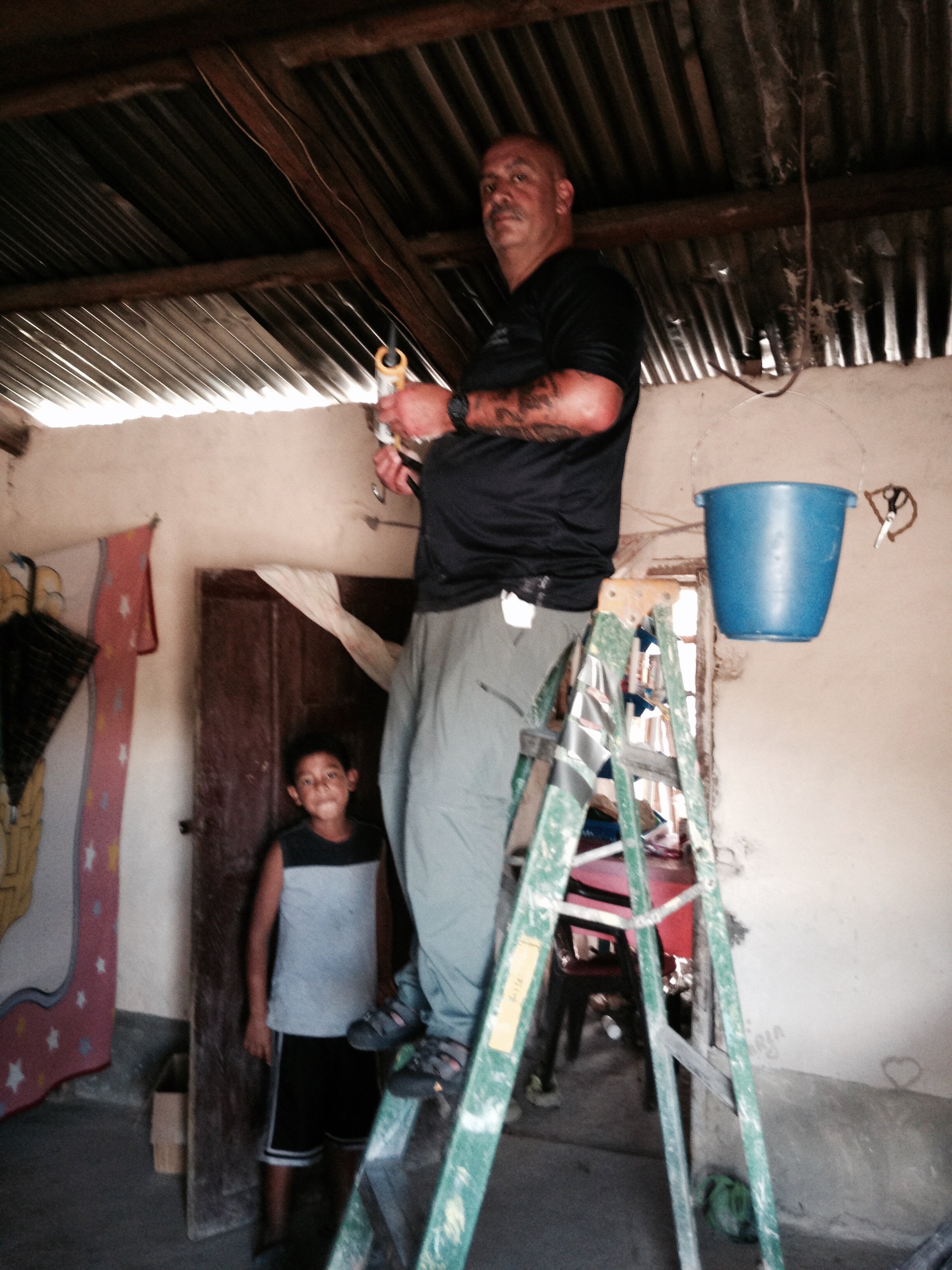 Team member Dave fixing a roof.