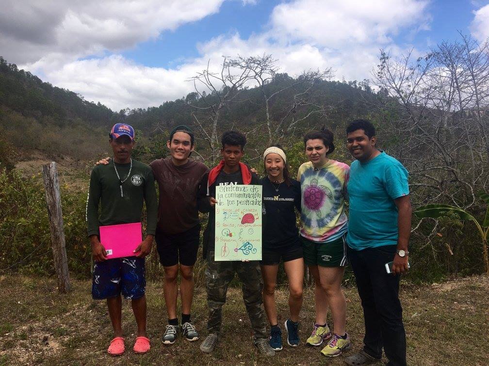 Fuerza students and a pesticide safety poster.