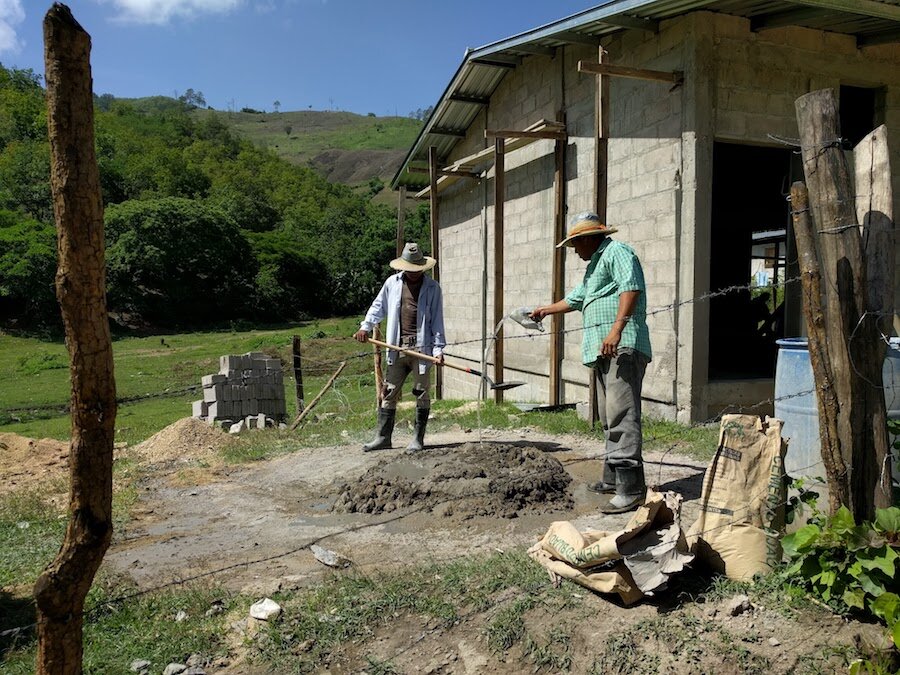 Mixing mortar for the new shower facility, part of the pesticide safety project.