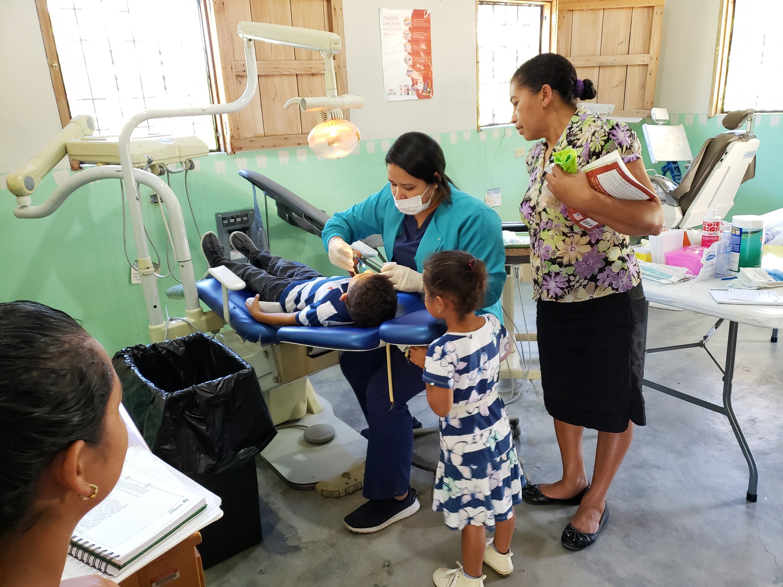 A young patient from El Rosario receives his first-ever dental evaluation during the Pediatric Jornada.