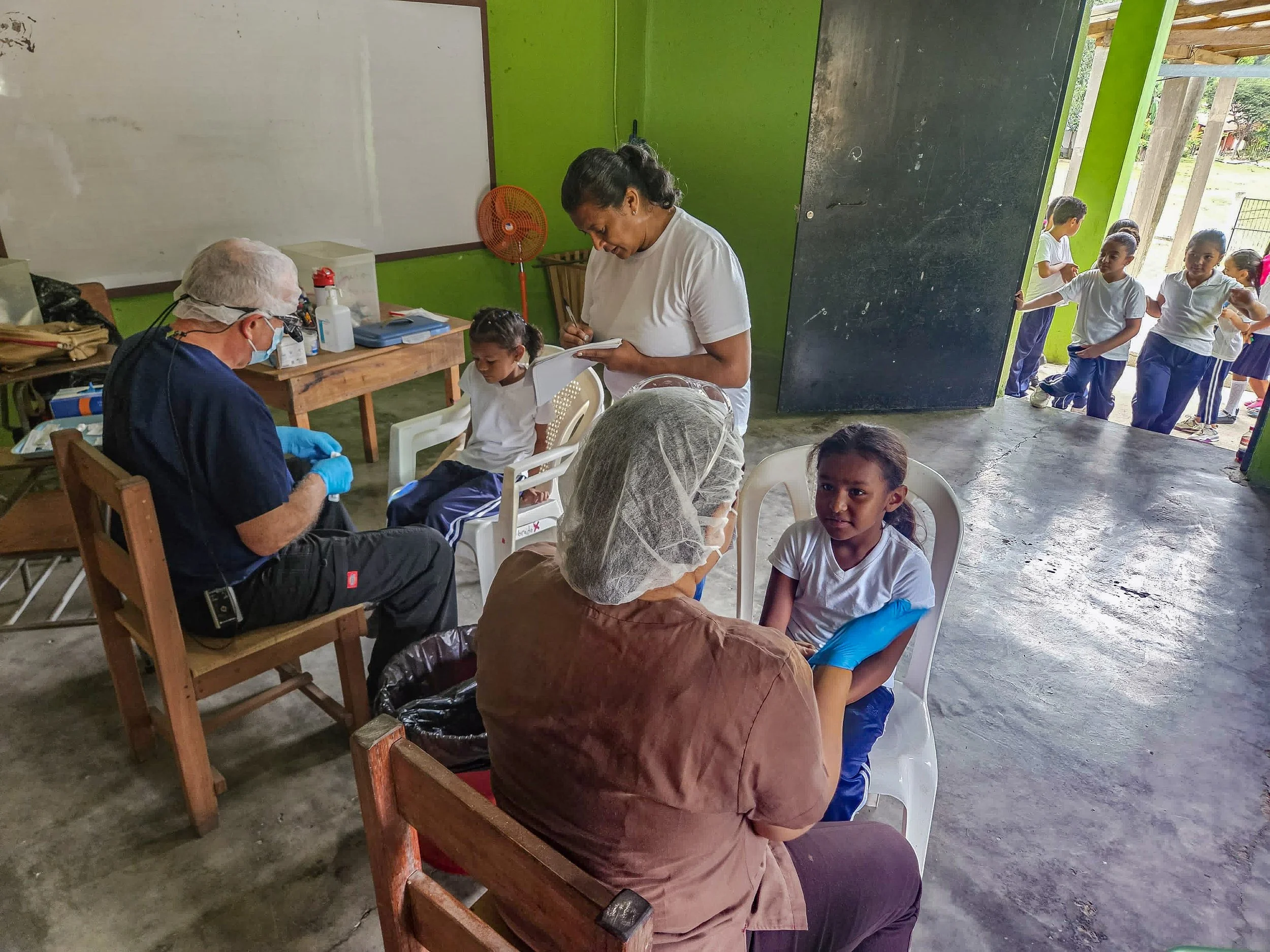 Dentist Reina and Assistant Sandra visit each of 11 elementary schools twice a year to see each child. They do fluoride treatments, teach dental hygiene, treat cavities, and identify children who should be followed up at the Dental Clinic.