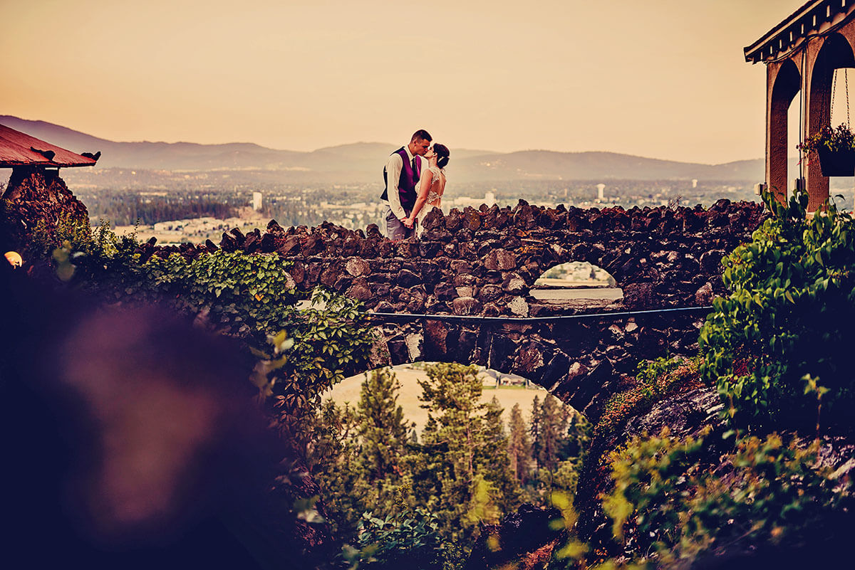 A photo of a bride and groom on the bridge connecting to the Cliff House Estate 