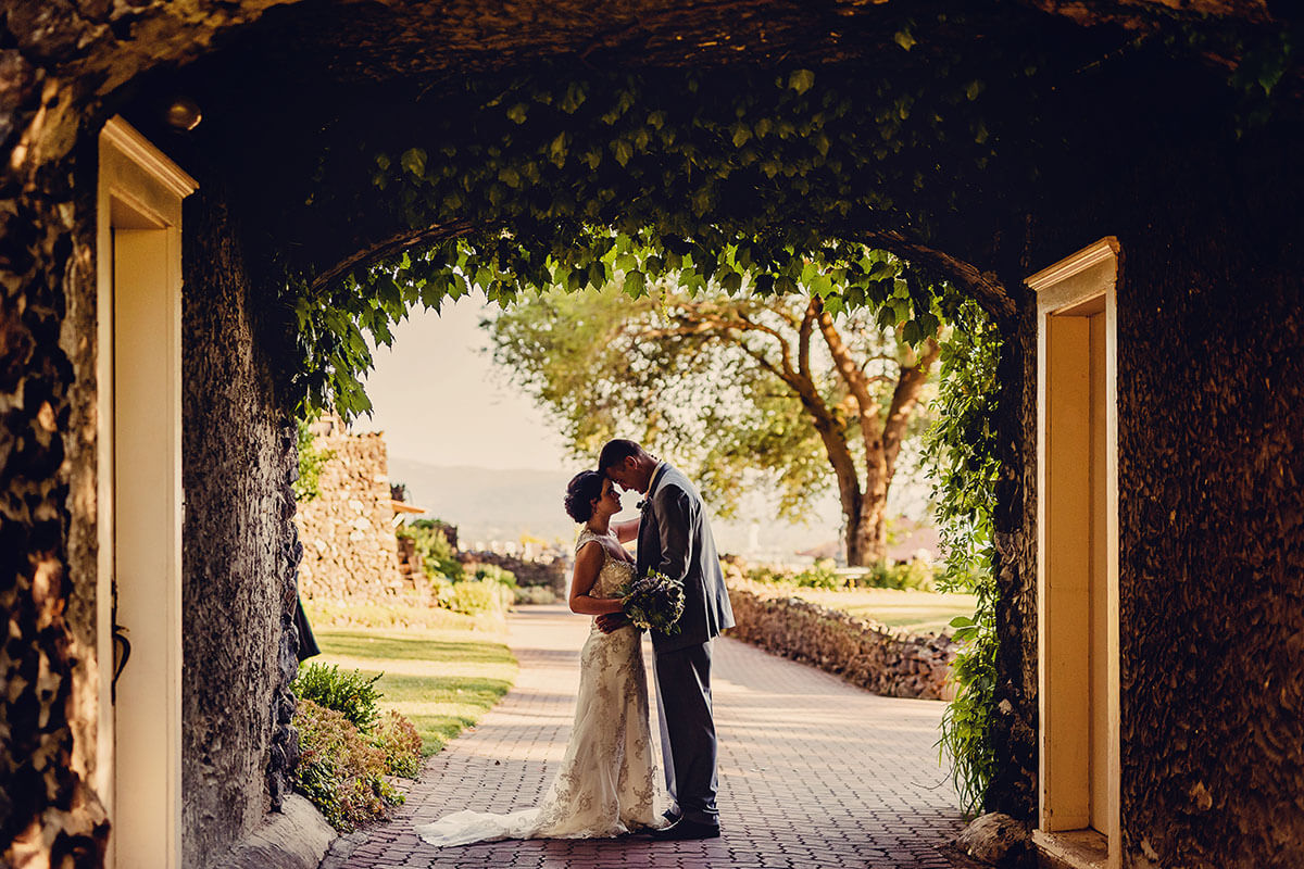 A photo of a couple kissing in the gatehouse 