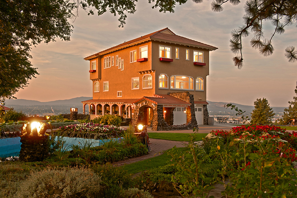 an image of the Cliff House Estate at sunset with glowing lights in the Estate grounds