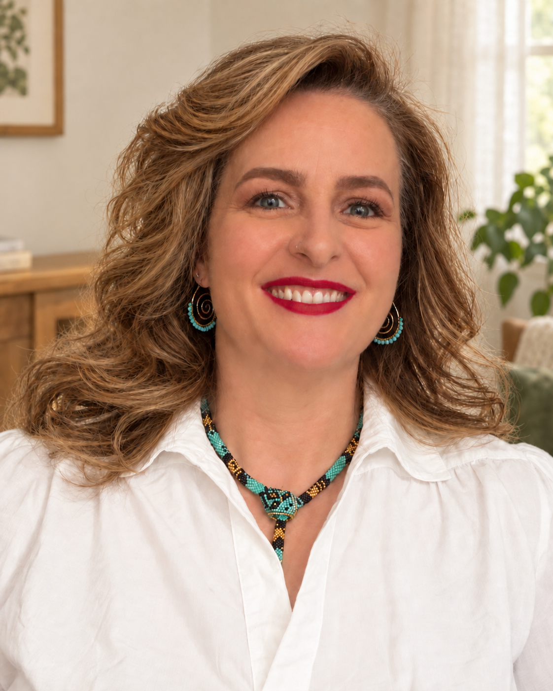 Paulette Dawson smiling in a white blouse with turquoise jewelry.