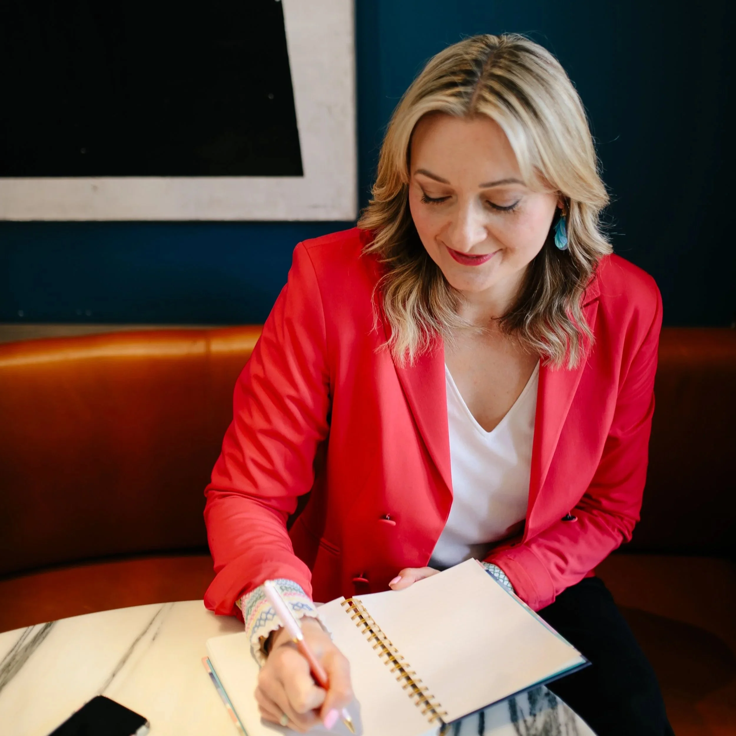 Laura Ogilvie-Jones, Career and Leadership Coach, writing in a notebook