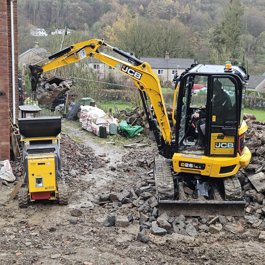 Crusher being loaded by JCB.png