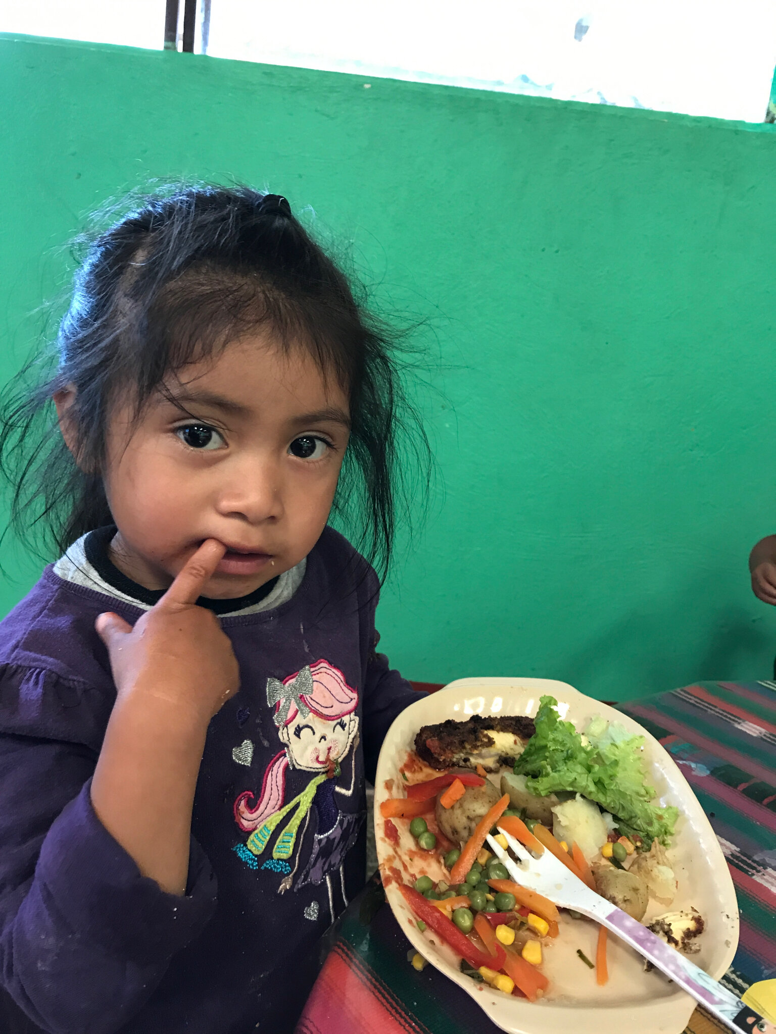 Little Girl from Guatemala Shares a Meal with Maryknoll Affiliates