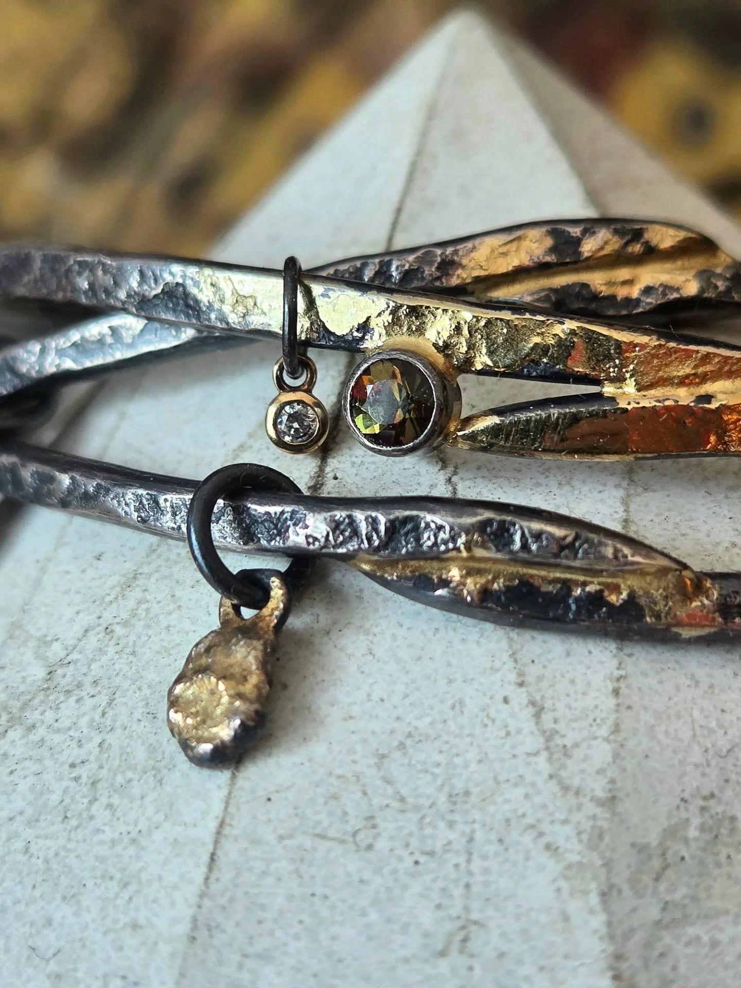 New Ascendant overlapping bangle bracelets will be with me this weekend at @stjamescourtartshow
🌬🍂🌋
Forged and textured on my favorite rusty piece of old railroad track, each cratered inch of silver holds an echo of the past. I overlapped and tape