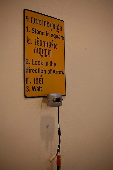 Stand Here and Wait - Detail camera, traffic signage, duct tape 2011