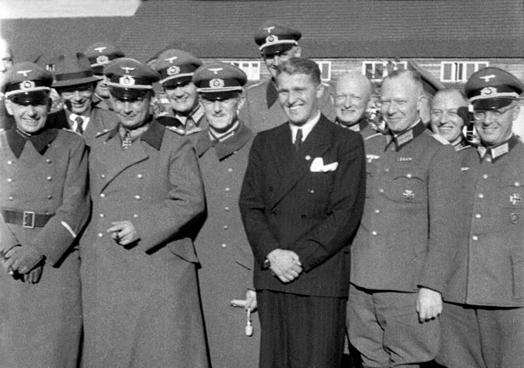 Pictured as the only guy not in uniform amongst his peers: Herr Von Braun.