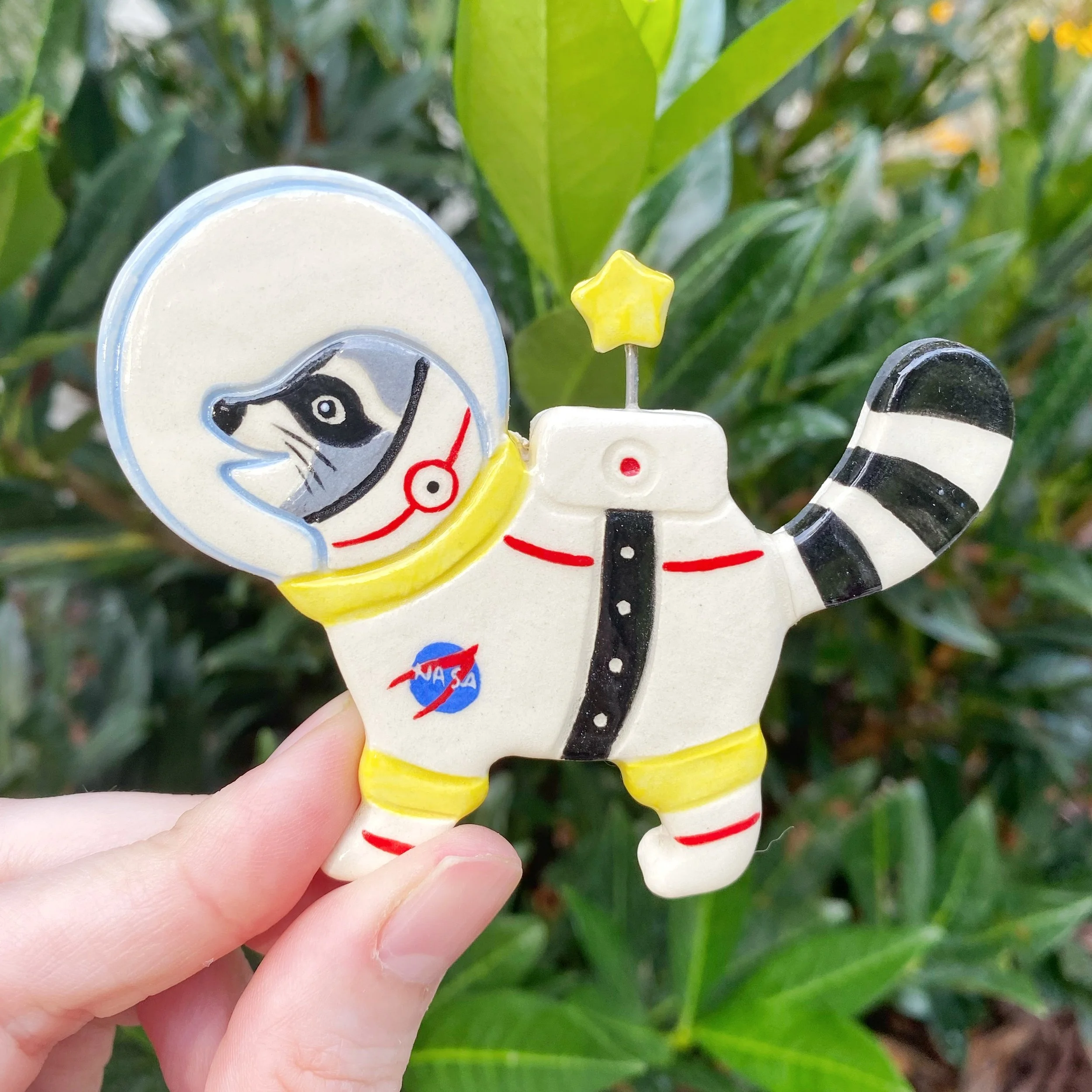 seconds_raccoon_astronaut_white_magnet_1.jpeg