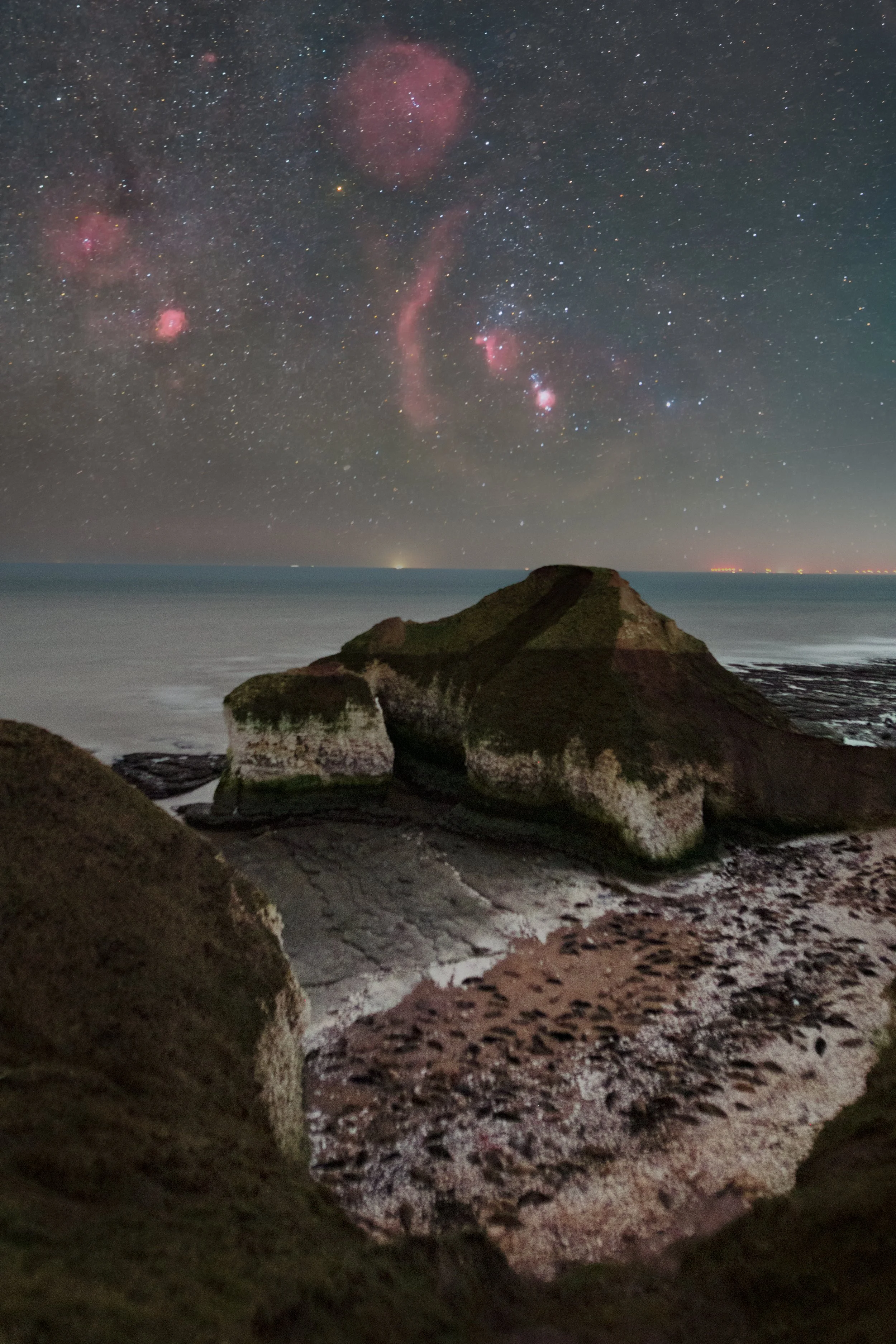 Orion constellation above the Drinking Dinosaur rock formation at Flamborough Head, captured as a widefield astrophotography print